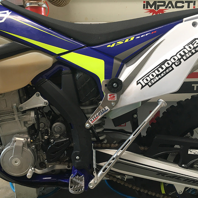 Close-up of a Sherco dirt bike with in a garage setting stegpegz