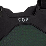 Close-up of a black and green protective vest with 'FOX' branding on a white background