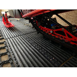 Red and black mechanical equipment on a textured surface
