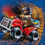 Toy figure on a red ATV with a blue background