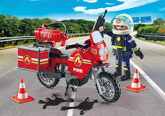 Playmobil fire motorcycle with firefighter figure on a road with traffic cones.