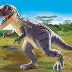 Toy dinosaur model in a prehistoric landscape with trees and grass.
