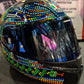 Colorful helmet with sequin embellishments on a reflective surface