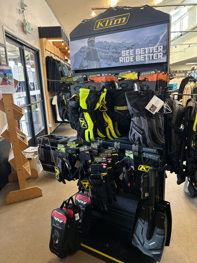 Motorcycle parts and accessories on the shelves at Sisters Moto