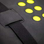 Black bag with yellow circular patterns and a strap