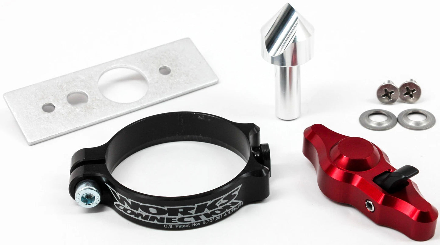Mechanical parts including a black clamp, red component, and metal plate on a white background