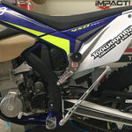 Close-up of a Sherco dirt bike with in a garage setting stegpegz